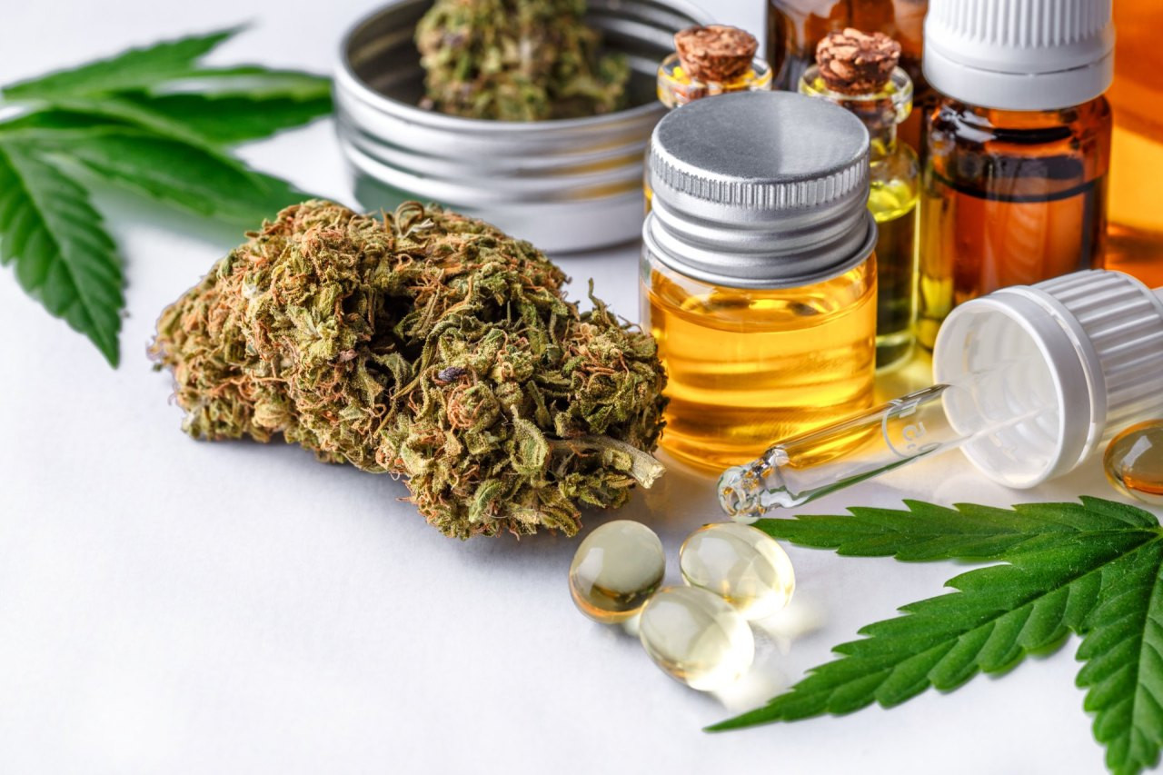 Cannabisblüten, Cannabisöl und Kapseln auf einem Tisch