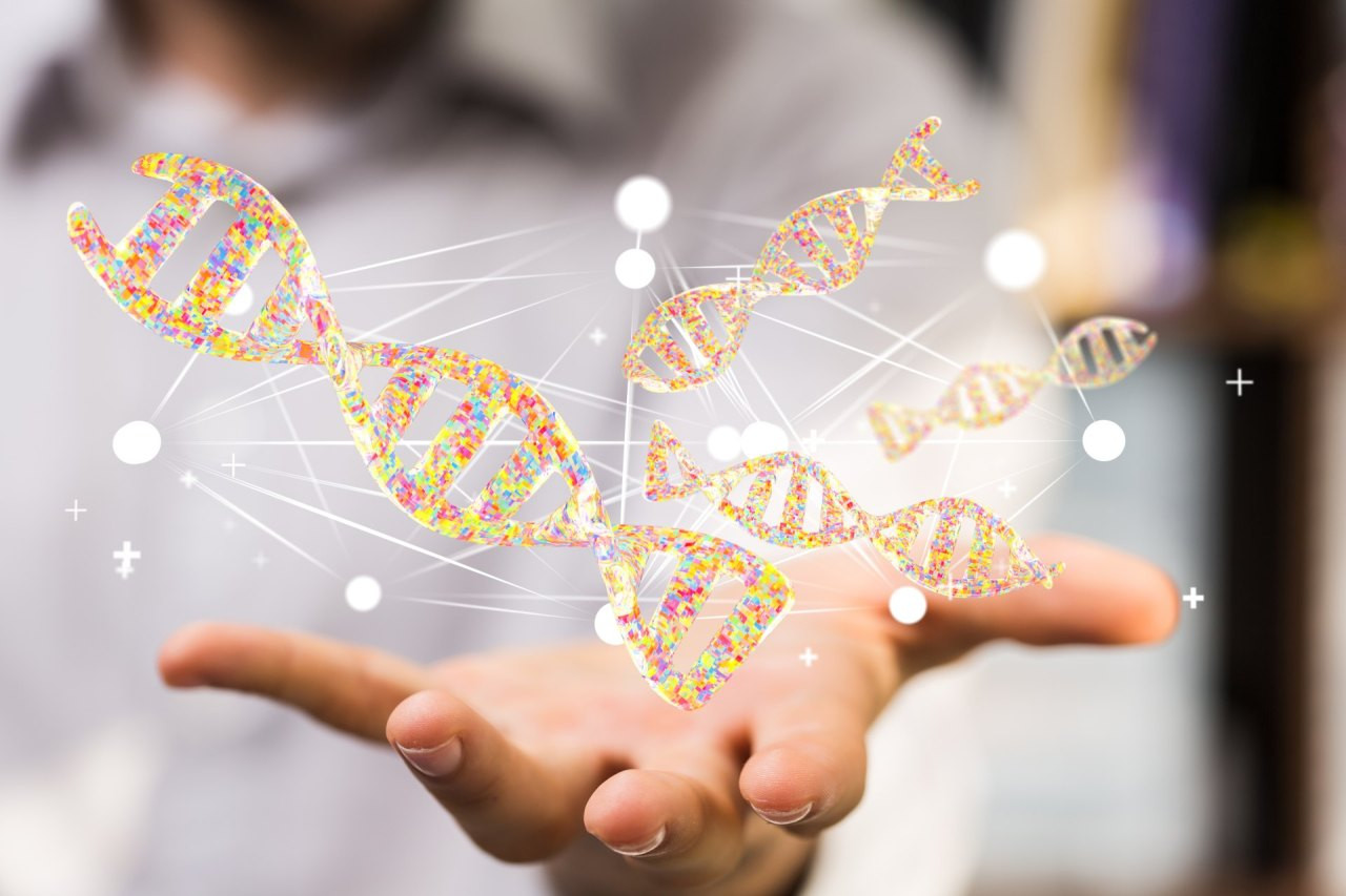 Eine geöffnete Hand, über der mehrere stilisierte, gelb‑orangefarbene DNA‑Doppelhelix‑Grafiken schweben