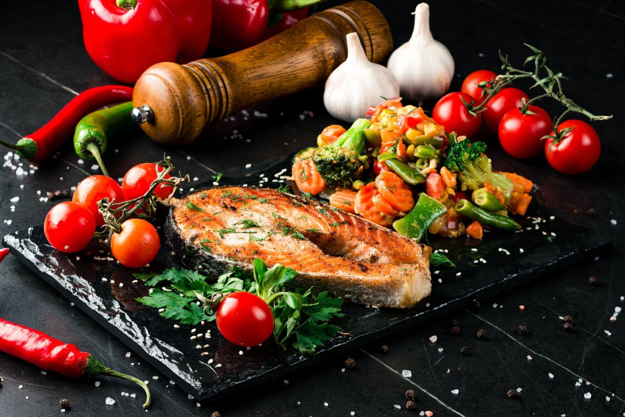 Steam salmon and vegetables, Paleo, keto, fodmap diet on old rustic wooden table