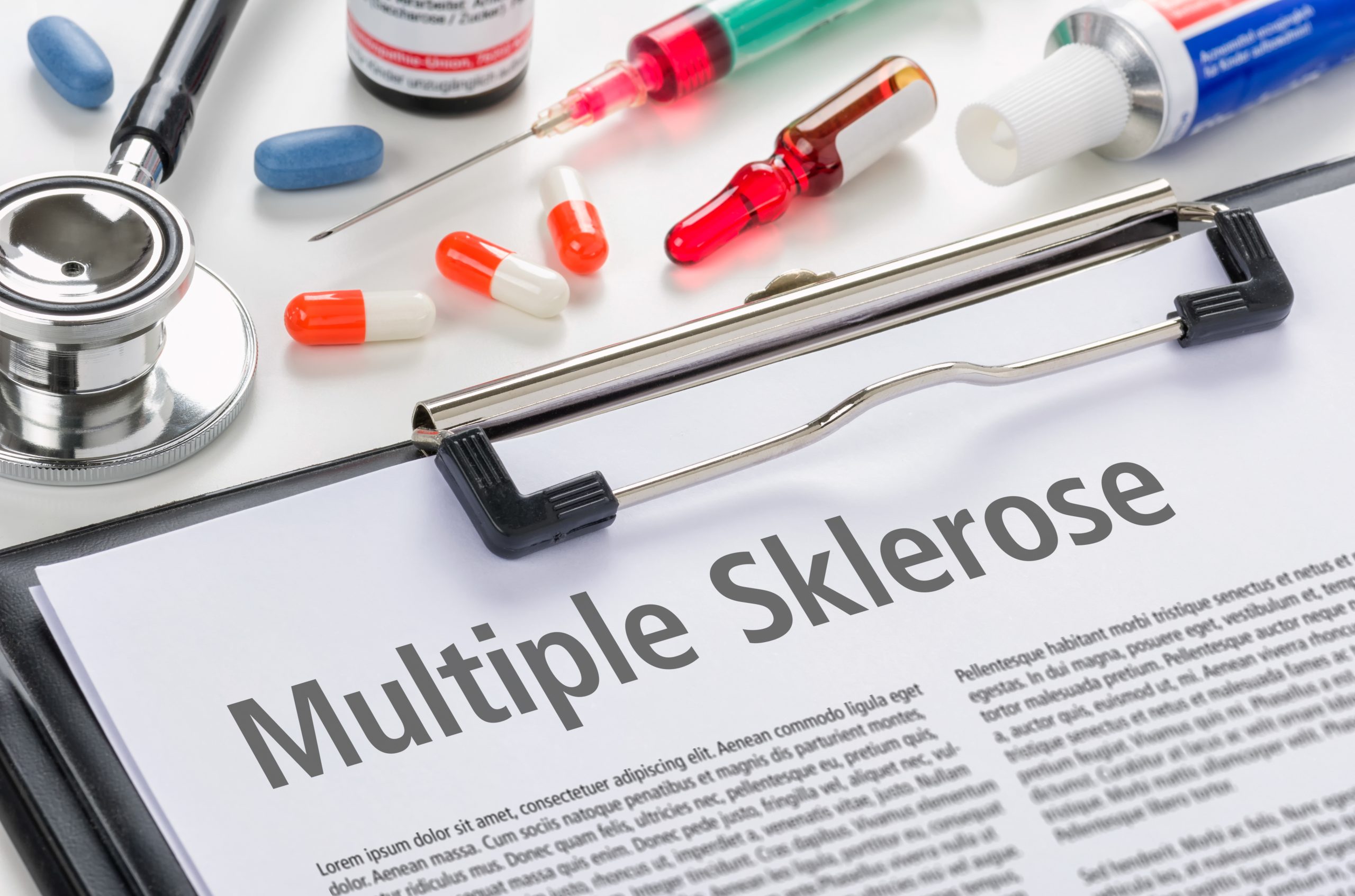 Klemmbrett mit Unterlagen zu Multiple Sklerose und Arztutensilien.