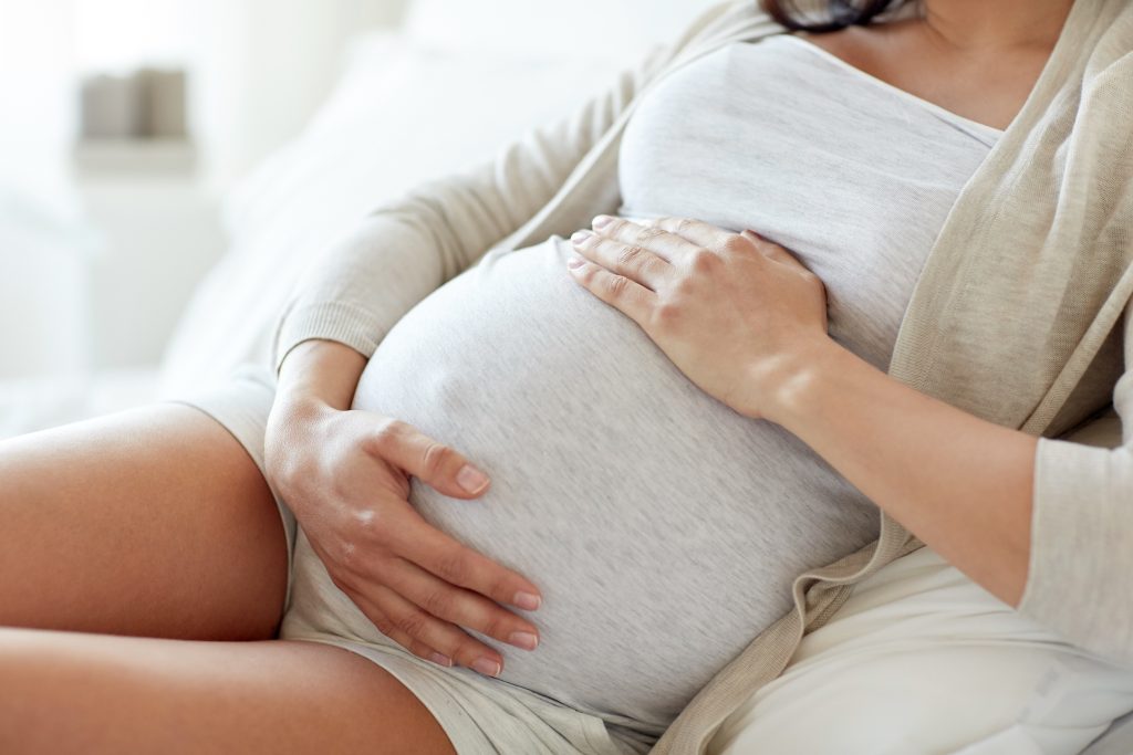 close up of pregnant woman lying in bed