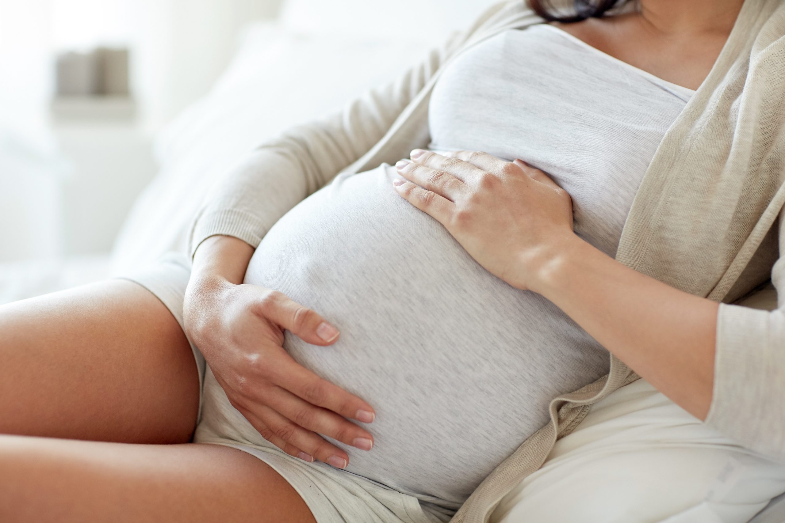 close up of pregnant woman lying in bed