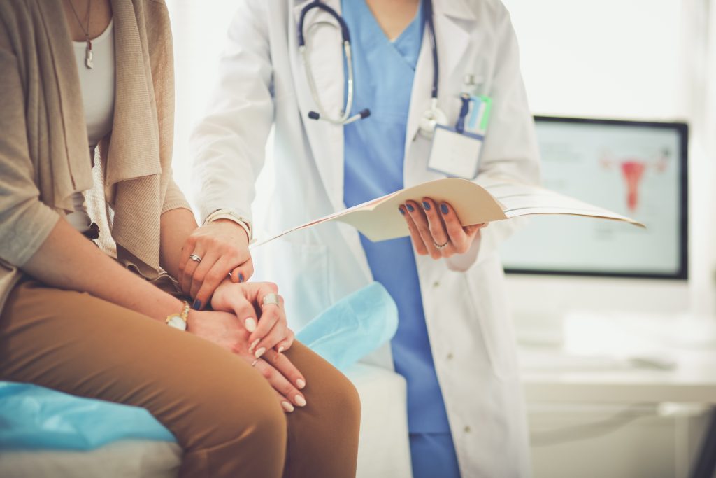 Doctor and patient discussing something while sitting at the table . Medicine and health care concept. Doctor and patient.